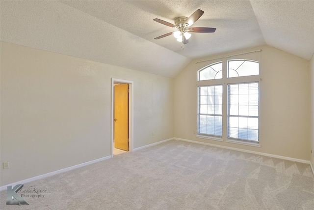 additional living space with plenty of natural light, light colored carpet, and lofted ceiling