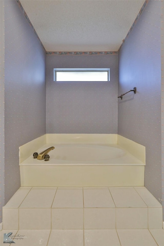 bathroom with tile patterned flooring, plenty of natural light, and a textured ceiling