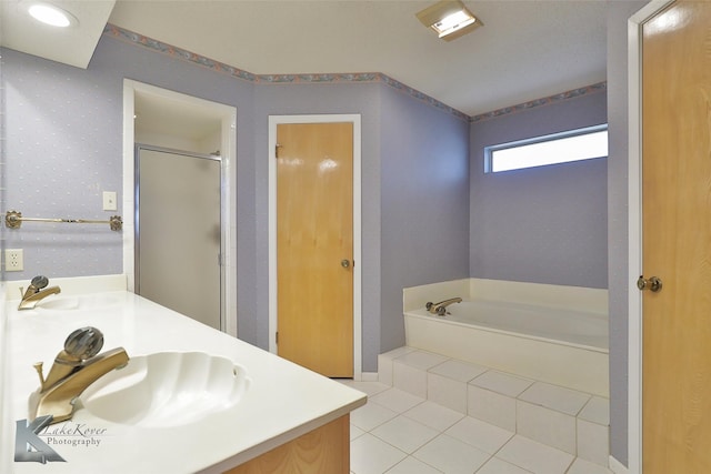 bathroom featuring shower with separate bathtub, tile patterned floors, and vanity