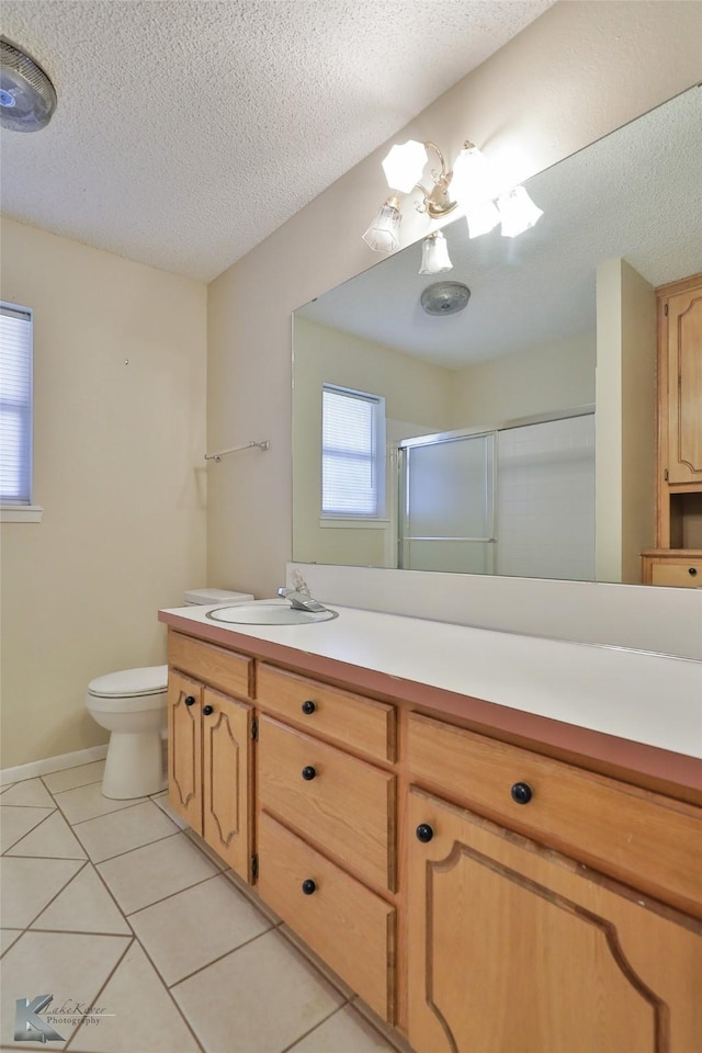 bathroom with walk in shower, tile patterned floors, toilet, a textured ceiling, and vanity