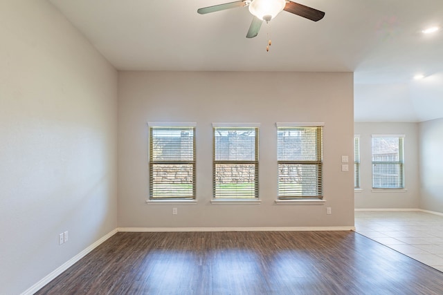 spare room featuring dark hardwood / wood-style flooring and ceiling fan