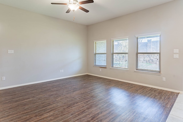 unfurnished room with ceiling fan and dark hardwood / wood-style flooring