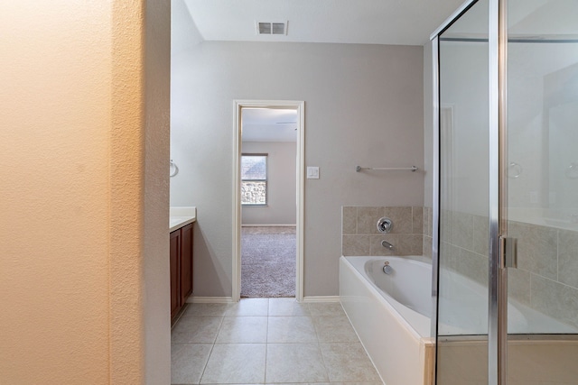 bathroom with tile patterned floors, vanity, and independent shower and bath