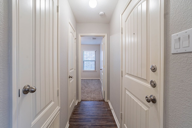 hallway with dark wood-type flooring