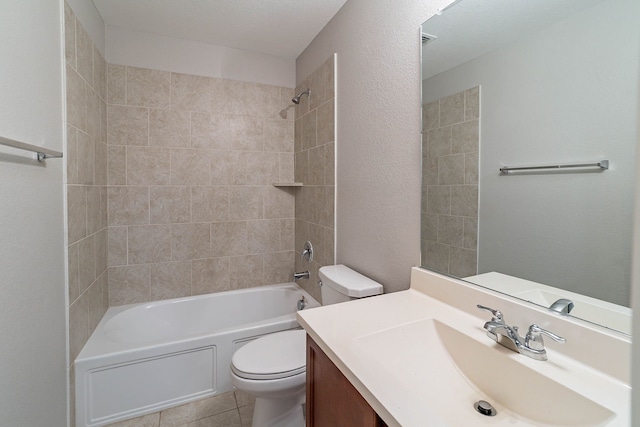 full bathroom with vanity, tiled shower / bath combo, tile patterned floors, and toilet