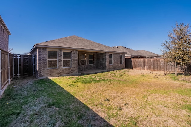 back of house with a yard