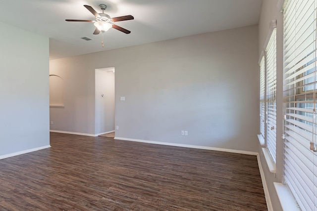 spare room with dark hardwood / wood-style flooring and ceiling fan