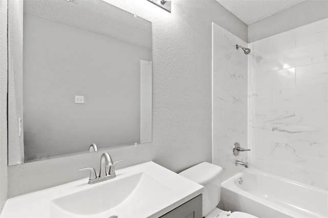 full bathroom featuring tiled shower / bath, vanity, toilet, and a textured ceiling