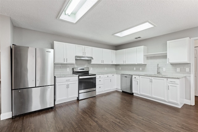 kitchen with stainless steel appliances, white cabinetry, sink, and dark hardwood / wood-style flooring