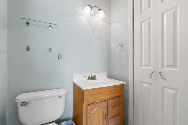 bathroom featuring toilet and vanity