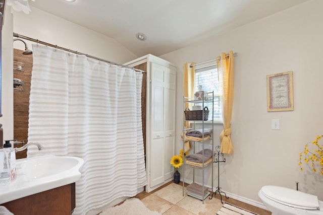 bathroom featuring toilet, vaulted ceiling, curtained shower, tile patterned floors, and vanity