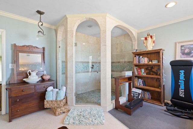 bathroom featuring crown molding and a shower with door