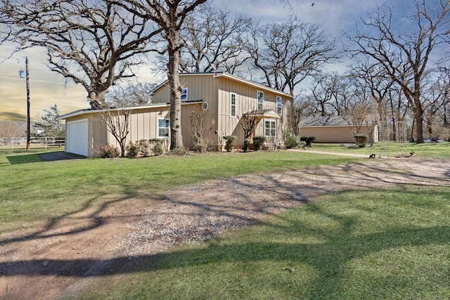 exterior space featuring a lawn and a garage