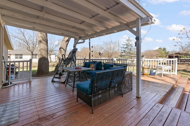 wooden deck with an outdoor living space