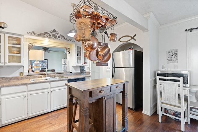 kitchen featuring appliances with stainless steel finishes, sink, dark hardwood / wood-style flooring, and white cabinets