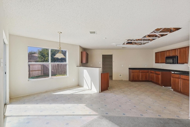 kitchen featuring hanging light fixtures and a textured ceiling