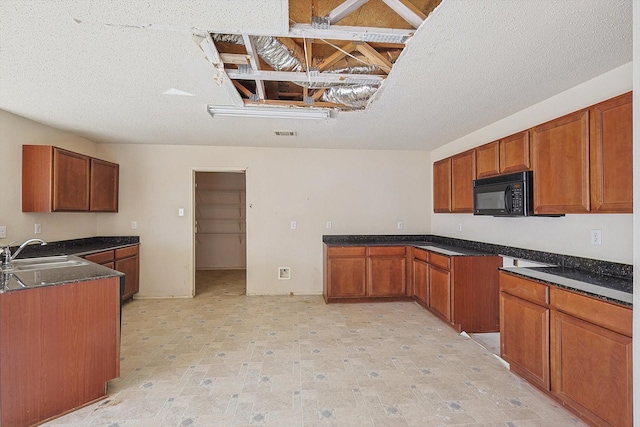 kitchen with sink and a textured ceiling