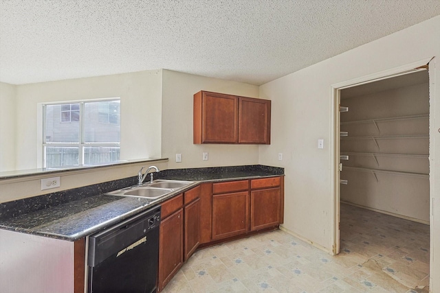 kitchen featuring black dishwasher, sink, and a textured ceiling