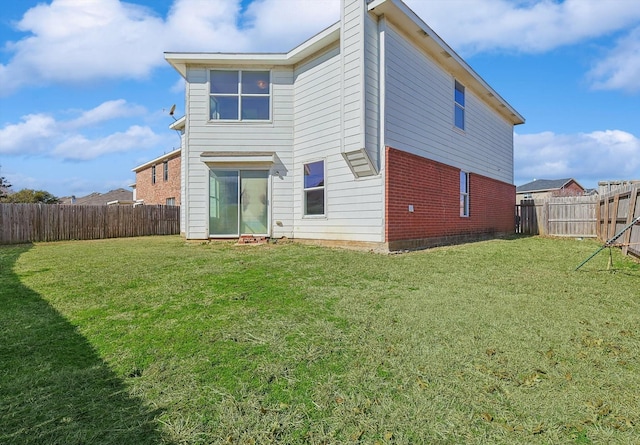 back of house featuring a yard