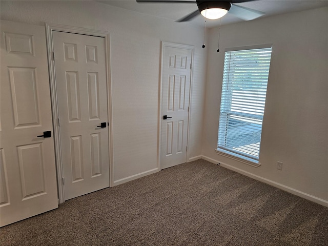 unfurnished bedroom featuring ceiling fan and carpet