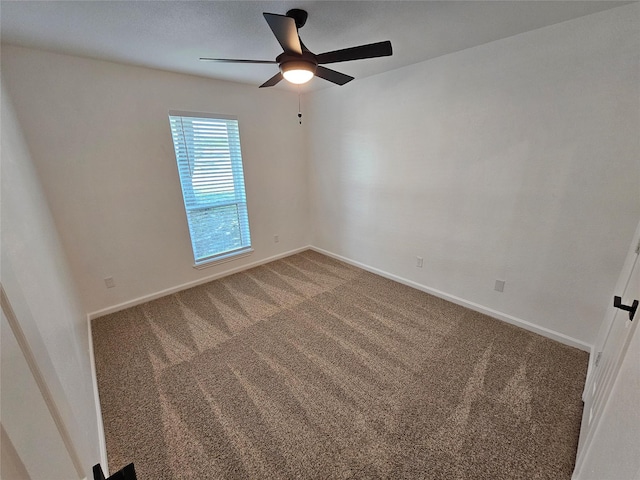 empty room featuring carpet floors and ceiling fan