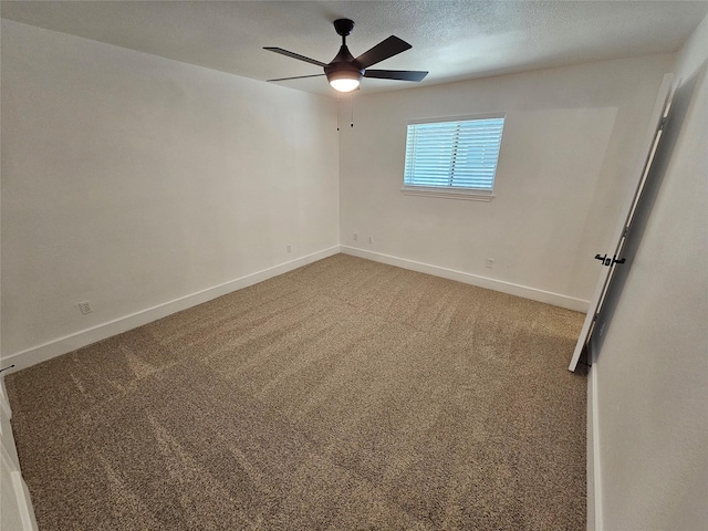 empty room with ceiling fan, carpet flooring, and a textured ceiling