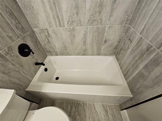 full bathroom featuring vanity, toilet, and tiled shower / bath combo