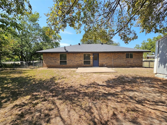 back of house with a yard and a patio area