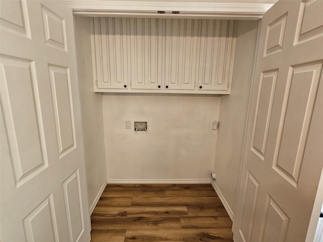 washroom with cabinets, hookup for a washing machine, and dark hardwood / wood-style floors