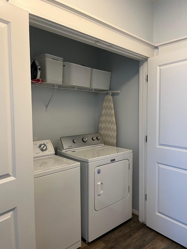 laundry room with dark wood-type flooring and washing machine and clothes dryer