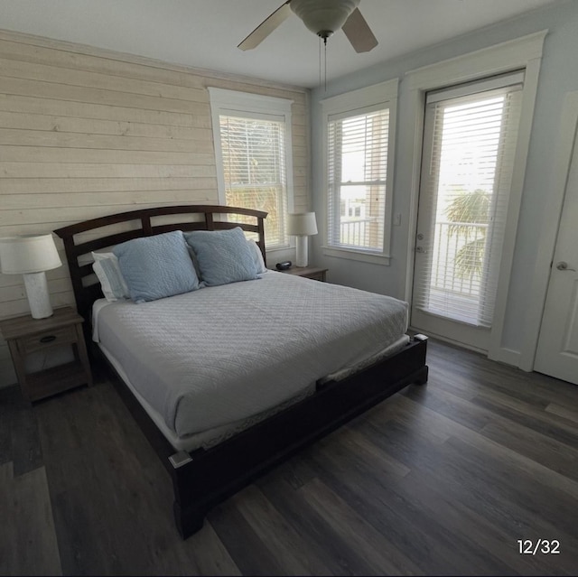 bedroom featuring ceiling fan, access to exterior, and dark hardwood / wood-style flooring