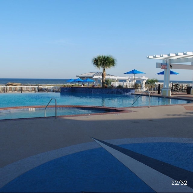 view of pool featuring a water view