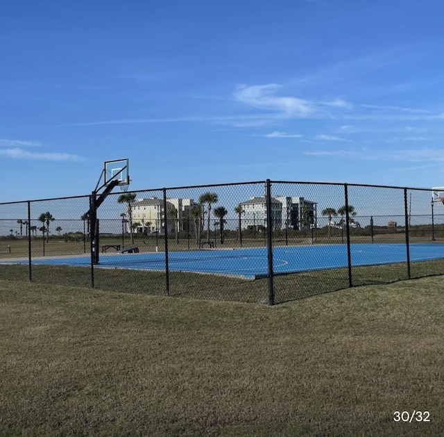 view of basketball court with a lawn