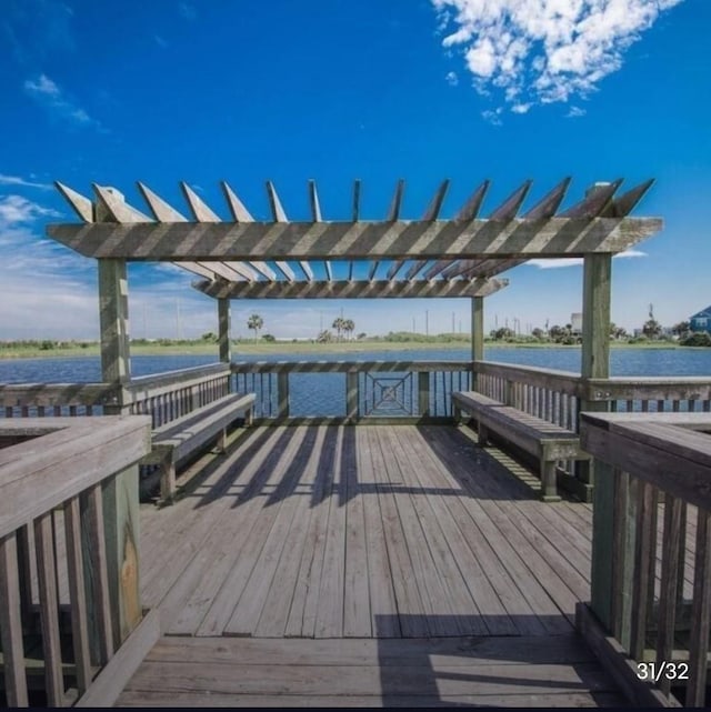 deck featuring a water view and a pergola