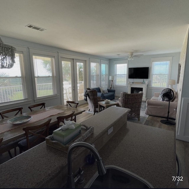 living room with ceiling fan, sink, and hardwood / wood-style floors