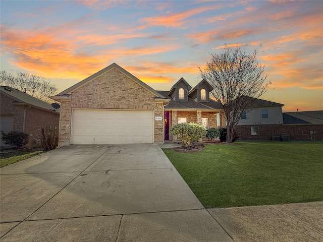 view of front facade with a garage and a yard