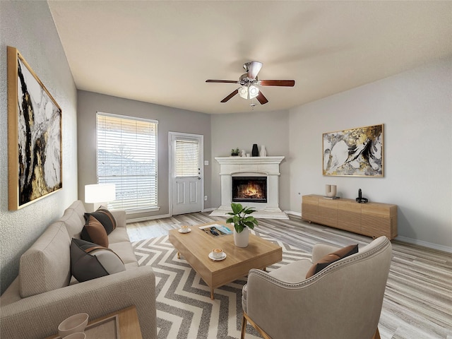 living room with ceiling fan and light wood-type flooring