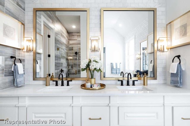 bathroom with vanity and a shower with door