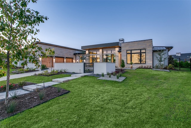 rear view of house featuring a lawn