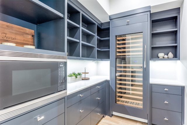 kitchen featuring beverage cooler and light wood-type flooring