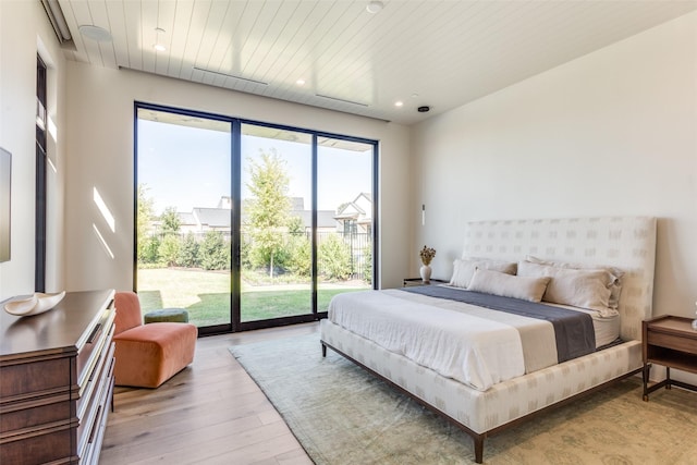 bedroom with hardwood / wood-style flooring, wooden ceiling, and access to outside