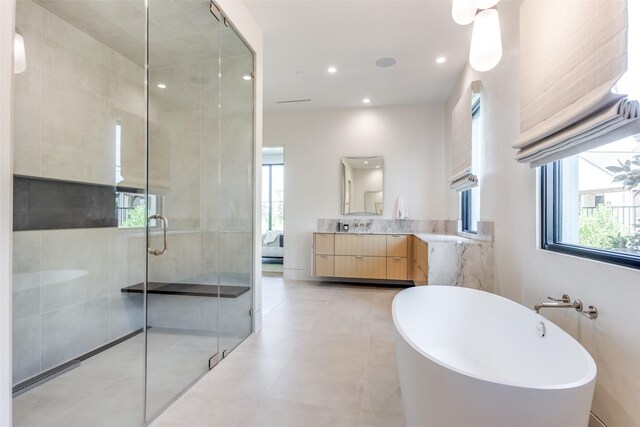 bathroom featuring vanity and separate shower and tub