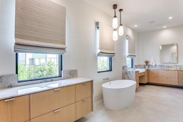 bathroom featuring vanity and a washtub