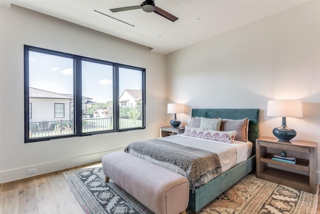 bedroom with ceiling fan and hardwood / wood-style floors