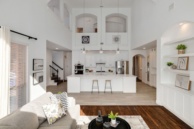 living room with wood-type flooring and built in features