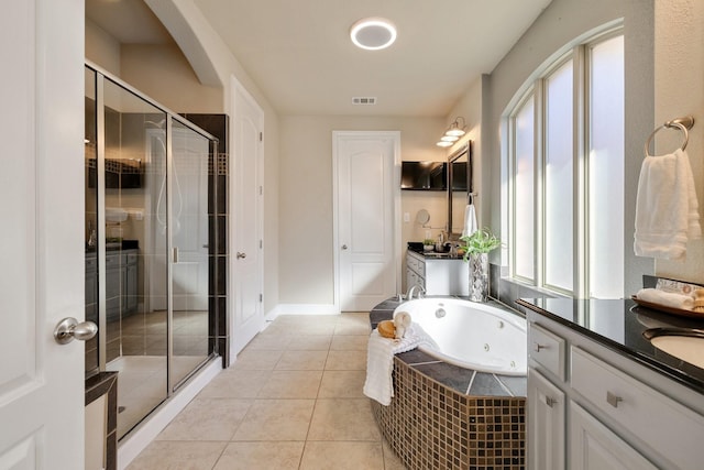 bathroom with independent shower and bath, vanity, and tile patterned floors