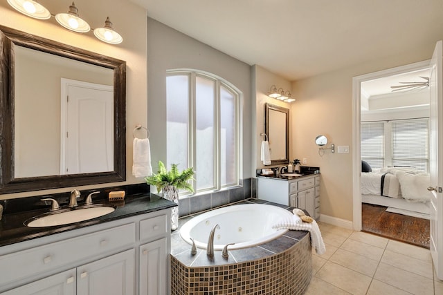 bathroom featuring vanity, tiled bath, and tile patterned flooring