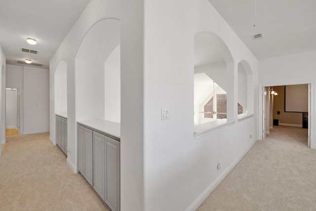 hallway with light colored carpet