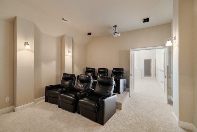 carpeted home theater room with vaulted ceiling