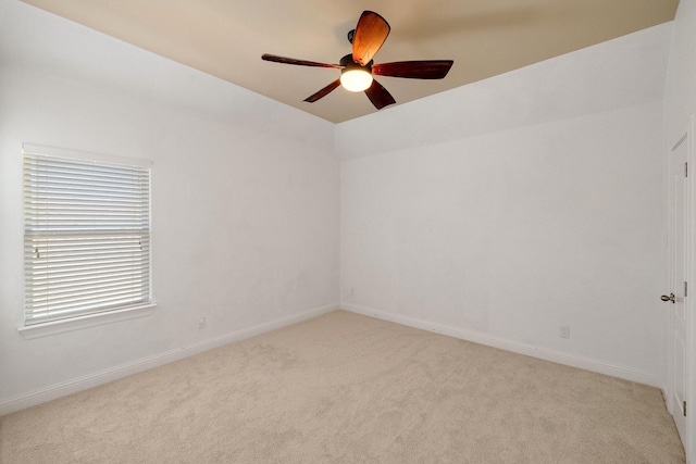 carpeted empty room featuring ceiling fan